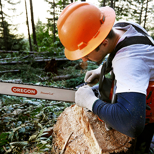 Man using chainsaw with PowerCut Guide Bar